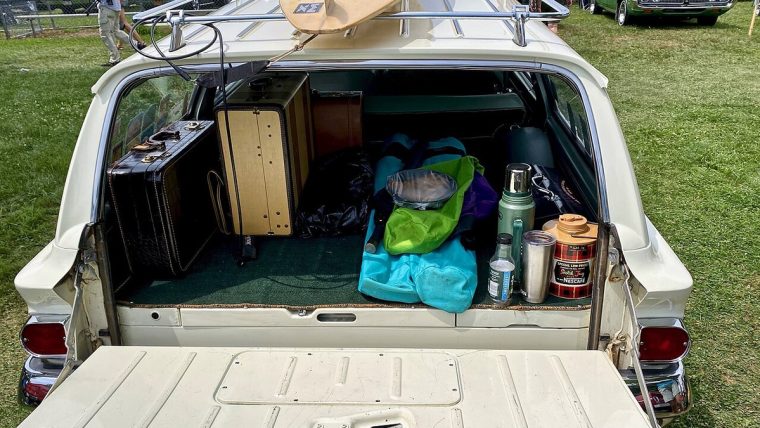 Packing cubes and travel pouches arranged inside an open suitcase