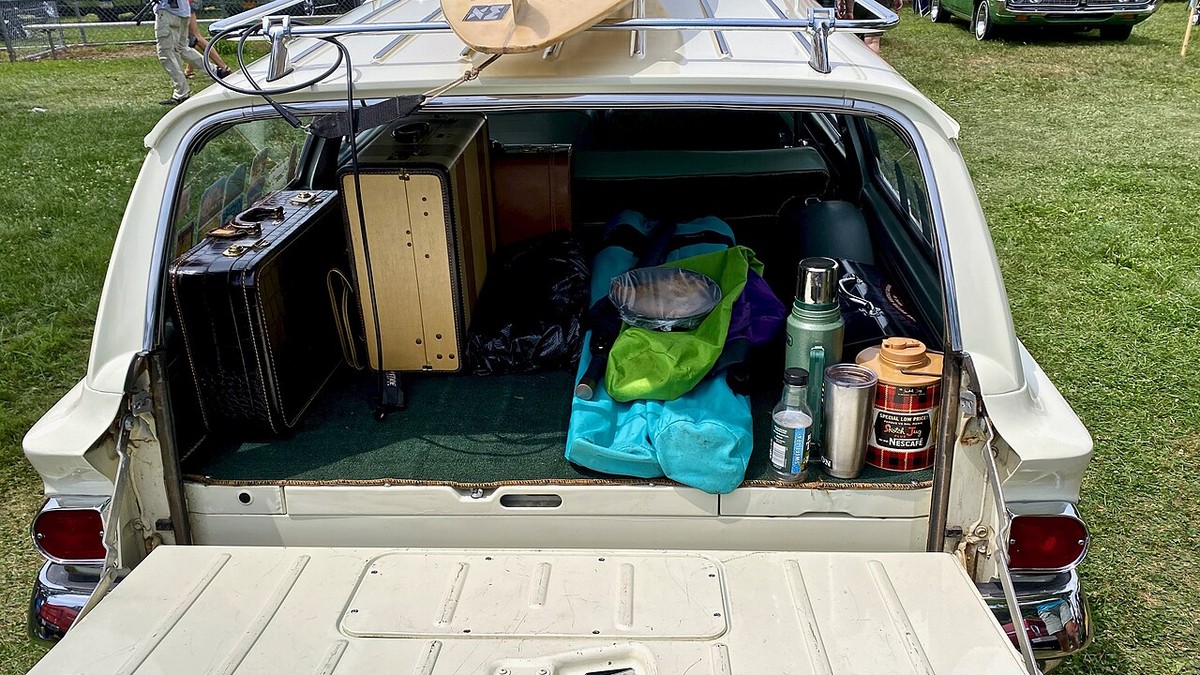 Packing cubes and travel pouches arranged inside an open suitcase