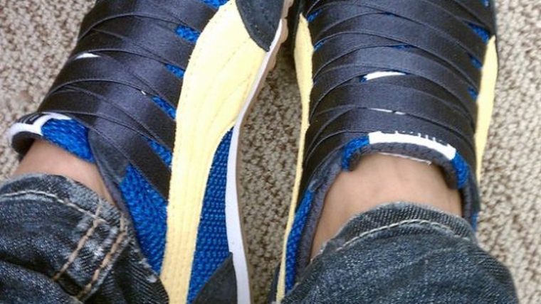 Side view of trendy casual sneakers worn with an everyday outfit
